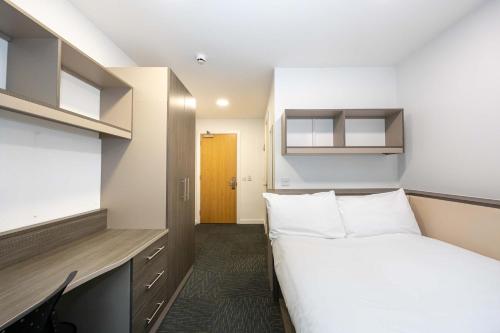 a small room with a bed and a tv at Single Ensuite Rooms In Central Preston in Preston