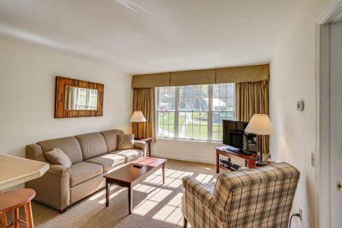 a living room with a couch and a tv at Ski in-out, Slope and Pool Views 1BR at Country Inn in Hancock
