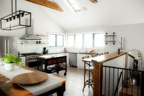a kitchen with a table and a counter in it at The Fisherman's Cottage in Cape May