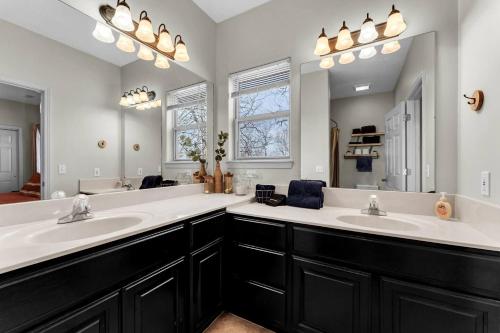 a bathroom with two sinks and a large mirror at Gorgeous Resort, Fish Private Lake, Pools, Golf! in Branson West