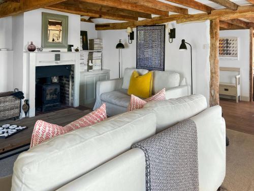 a living room with a couch and a fireplace at Prospect Cottage in Wittersham