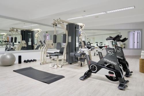 a gym with treadmills and exercise bikes in it at Caloura Hotel Resort in Caloura