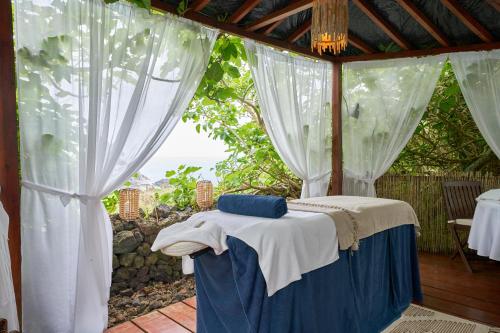 a bed in a room with a window at Caloura Hotel Resort in Caloura