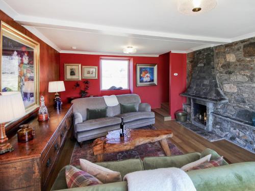 a living room with a couch and a fireplace at Coelard The Barn - Uk50538 in Appin