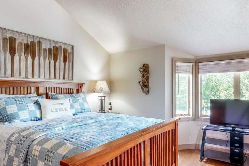a bedroom with a bed and a flat screen tv at The Boat House w/ Dock: Enjoy Lake Life! in North Webster