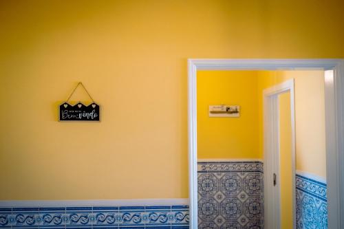 a door to a room with a sign on the wall at Vagueira beach in Praia da Vagueira