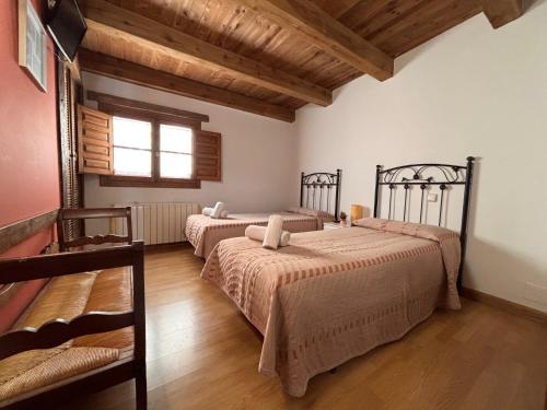 a bedroom with two beds and a window at El manzano in Castrojeriz