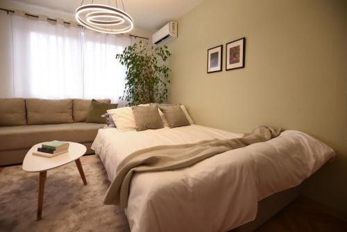 a living room with two beds and a couch at M&S Central Residence in Bitola