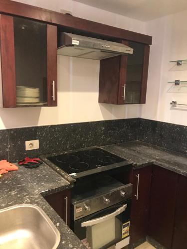a kitchen with a stove top oven next to a sink at Oyster bey Beach Suites J1-04 in Marsa Alam