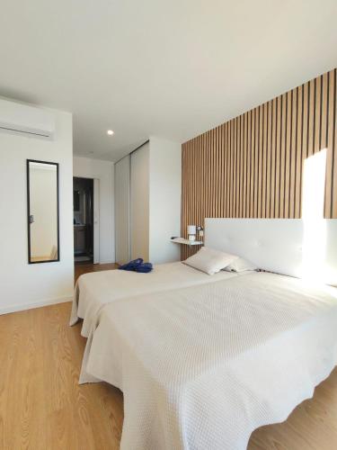 a bedroom with two beds and a mirror at Villa Arco in Vila Flor