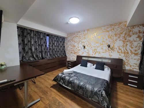 a bedroom with a bed and a desk in it at MAG Motel in Bucharest