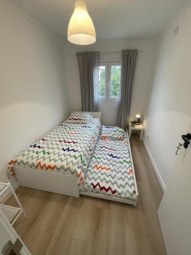 a bedroom with a bed and a window at The Lemon Tree Villa in Charneca