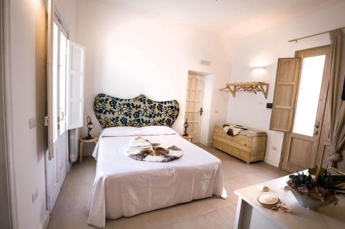a bedroom with a bed and a table and a chair at Il Borgo in Poggiardo