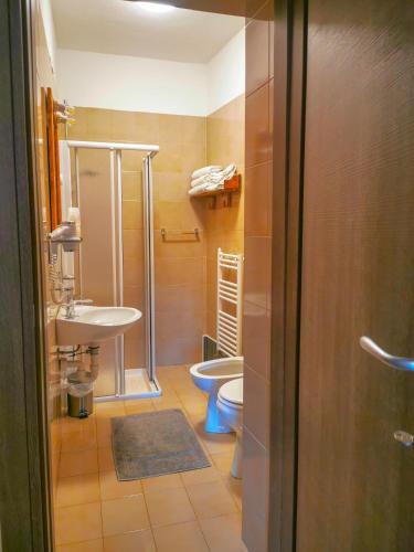 a bathroom with a toilet and a sink at Locanda Ponte Rosa in Garessio