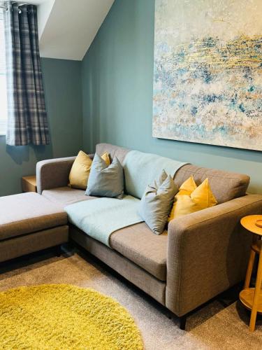 a couch with pillows on it in a living room at Quarry Heights in Bowness-on-Windermere