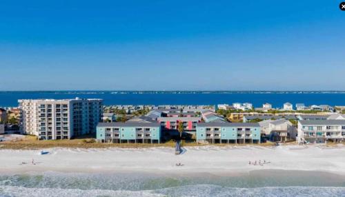 an aerial view of a beach with condos at Vibrant gulf condo with pool and beach access in Pensacola Beach