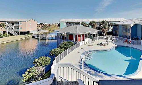 an aerial view of a house with a swimming pool at Vibrant gulf condo with pool and beach access in Pensacola Beach