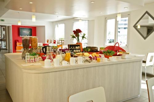 a buffet line with food on it in a restaurant at Première Classe Rosny Sous Bois in Rosny-sous-Bois