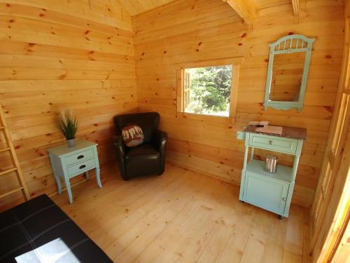 a room with a chair in a log cabin at Cozy Cabin #2 in Maynooth