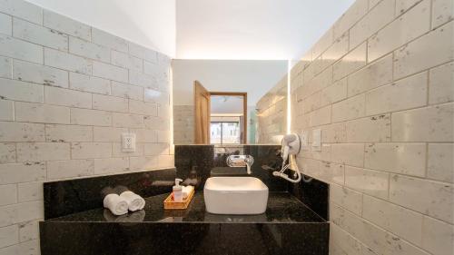 a bathroom with a sink and a phone on a counter at Casa Blú Huatulco in Santa Cruz Huatulco