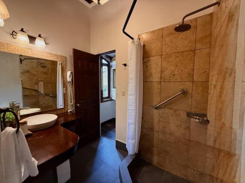 a bathroom with a shower and a sink at Tropicana La Catedral in Antigua Guatemala