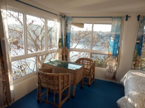 a bedroom with a table and chairs and a window at The Blue Apartment in Puerto Ángel