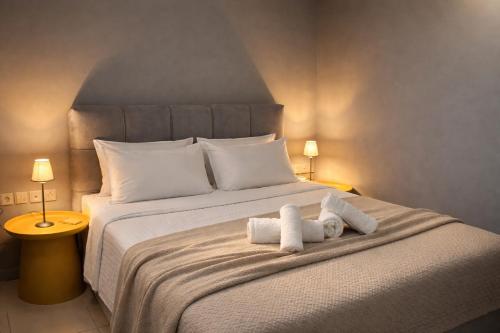 a bedroom with a bed with two stuffed animals on it at Urban Downtown Suite - Meno Homes 4 in Xanthi