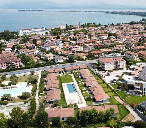 an aerial view of a city with houses and the water at Bungalow Ville d'Oro in Desenzano del Garda