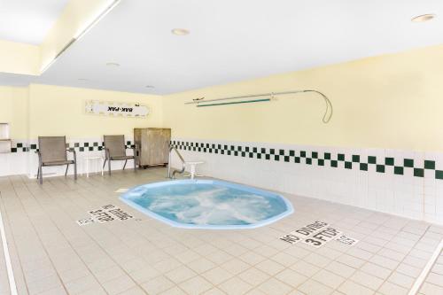 a large blue tub in a room with chairs at Comfort Inn in Marion