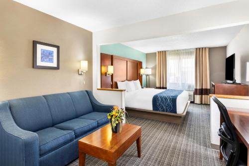 a hotel room with a couch and a bed at Comfort Inn in Marion