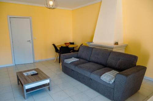a living room with a couch and a table at Vagueira beach in Praia da Vagueira