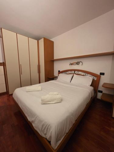 a bedroom with a bed with two towels on it at Rolly Home - Verona Apartment in Verona