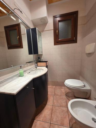 a bathroom with a sink and a toilet at Rolly Home - Verona Apartment in Verona