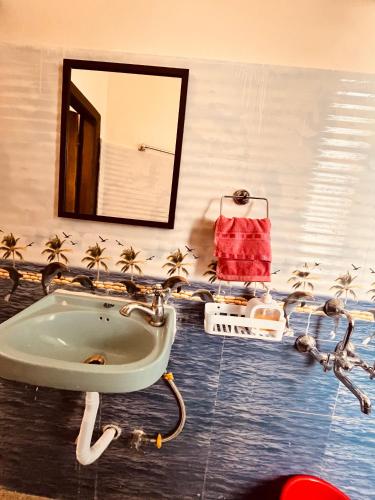 a bathroom with a sink and a mirror at Kusum Nest in Shillong