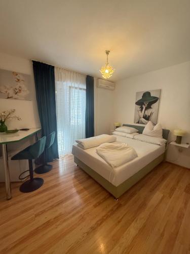 a bedroom with a bed and a desk in it at Apartments Ars Vivendi in Trogir