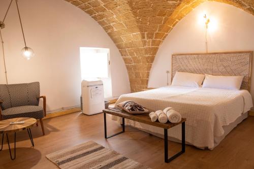a bedroom with a bed and a table and a chair at Chicca's Apartments Gallipoli in Gallipoli