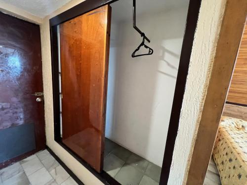 a door in a room with a hanger on the wall at Hotel De Cima Beach Club in Mazatlán