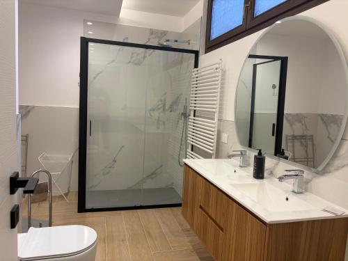 a bathroom with a shower and a sink and a mirror at Bilocale accogliente in centro Aprica in Aprica