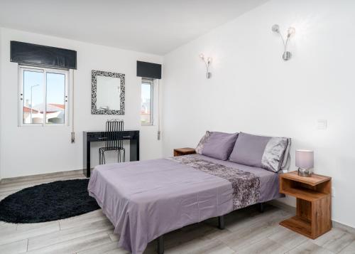 a white bedroom with a bed and a fireplace at Villa Garden - 22 Guests - 2 Pools in Albufeira