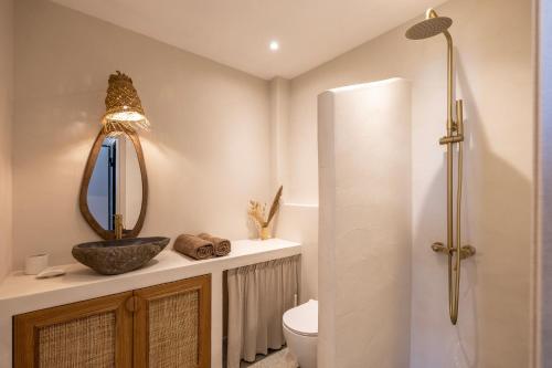 a bathroom with a toilet and a mirror at Cavo Dio 2 - Beachfront Bliss - Cozy Apt Pool Sunsets in Dhiminión