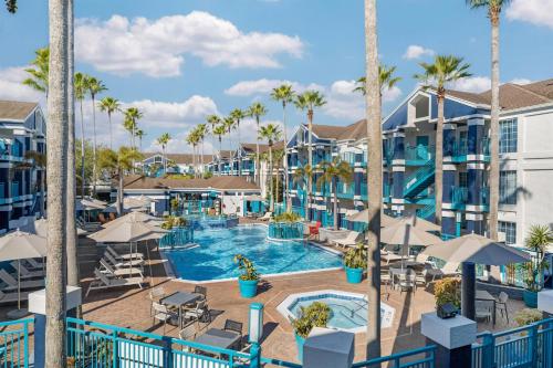 an image of a pool at a resort with palm trees at Sonesta ES Suites Orlando - Lake Buena Vista in Orlando
