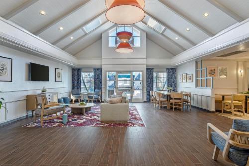 a large living room with tables and chairs at Sonesta ES Suites Orlando - Lake Buena Vista in Orlando