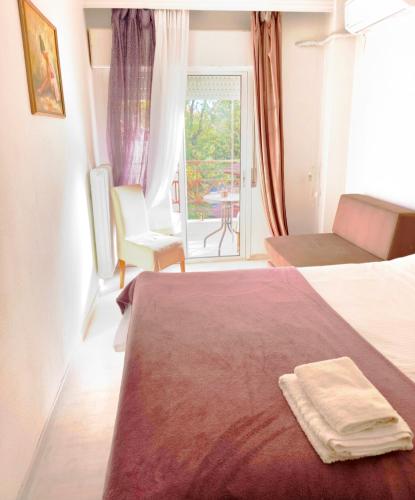a hotel room with a bed with a towel on it at FBM Anagenessis - Ευ Ζην 2 in Edessa