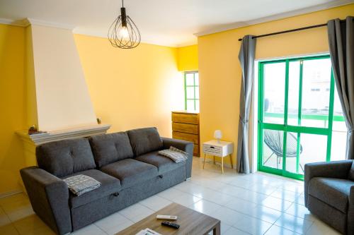 a living room with a couch and a table at Vagueira beach in Praia da Vagueira