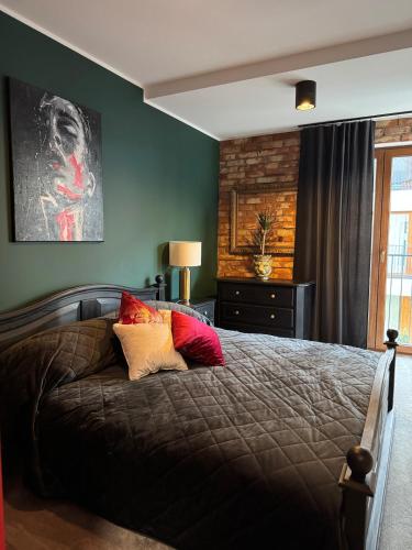 a bedroom with a bed with two pillows on it at Sunset Loft in Lubin