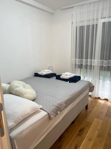 a bedroom with a bed with two pillows on it at VIP House 5 in Vrnjačka Banja