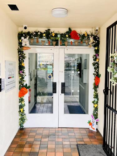 a front door of a store with flowers and plants at Fox House, Studio Apartments in Plymouth
