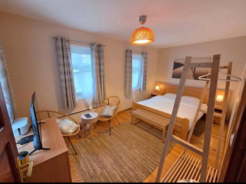 a bedroom with a bunk bed and a desk at Kucica Yuva in Vrnjačka Banja