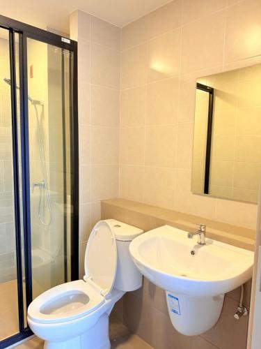 a bathroom with a toilet and a sink at Dcondo Reef kathu Patong in Kathu