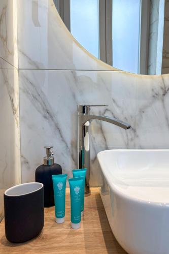 a bathroom with a sink and a bath tub at Dimore della Cisterna in Stresa